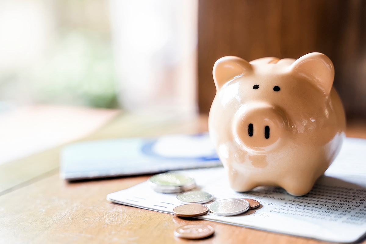 Piggy Bank on Desk with Coins